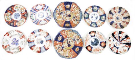 Group of Japanese imari porcelain dishes and plates, comprising seven scalloped plates and two