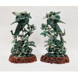 Pair of carved jadeite models of birds of paradise and other birds amidst foliage and flowers,