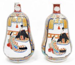 Pair of Japanese Meiji period (1868-1912) gourd-shaped imari vases, each painted with figures in