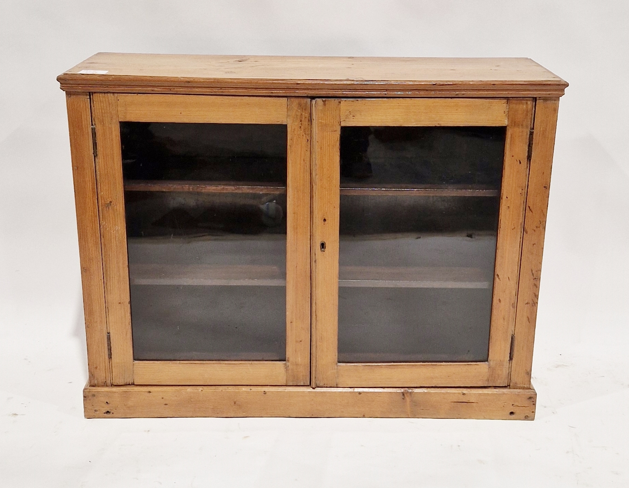 Victorian pine display cabinet, the two glazed doors opening to reveal two adjustable shelves,