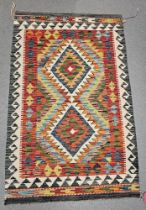 Chobi red ground kilim,  with two central lozenges on geometric zig-zag field, single geometric wave