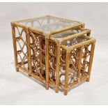 Nest of three stained bamboo and wicker side tables with glass tops, largest 54cm high x 50cm wide x