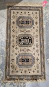 Belgian salmon ground silk rug with three central hooked octagonal medallions on stylised