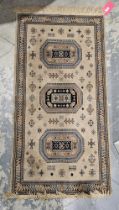 Belgian salmon ground silk rug with three central hooked octagonal medallions on stylised