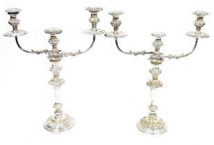 Pair of silver plated candelabra, each three light with removable foliate scroll drip trays, waisted