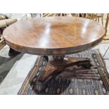 Large early Victorian rosewood tilt-top dining table of circular form, with carved floral central