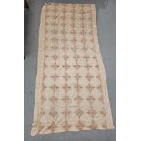 Embroidery wool shawl, cream ground with four rows of 14 coloured floral lozenges and five rows of