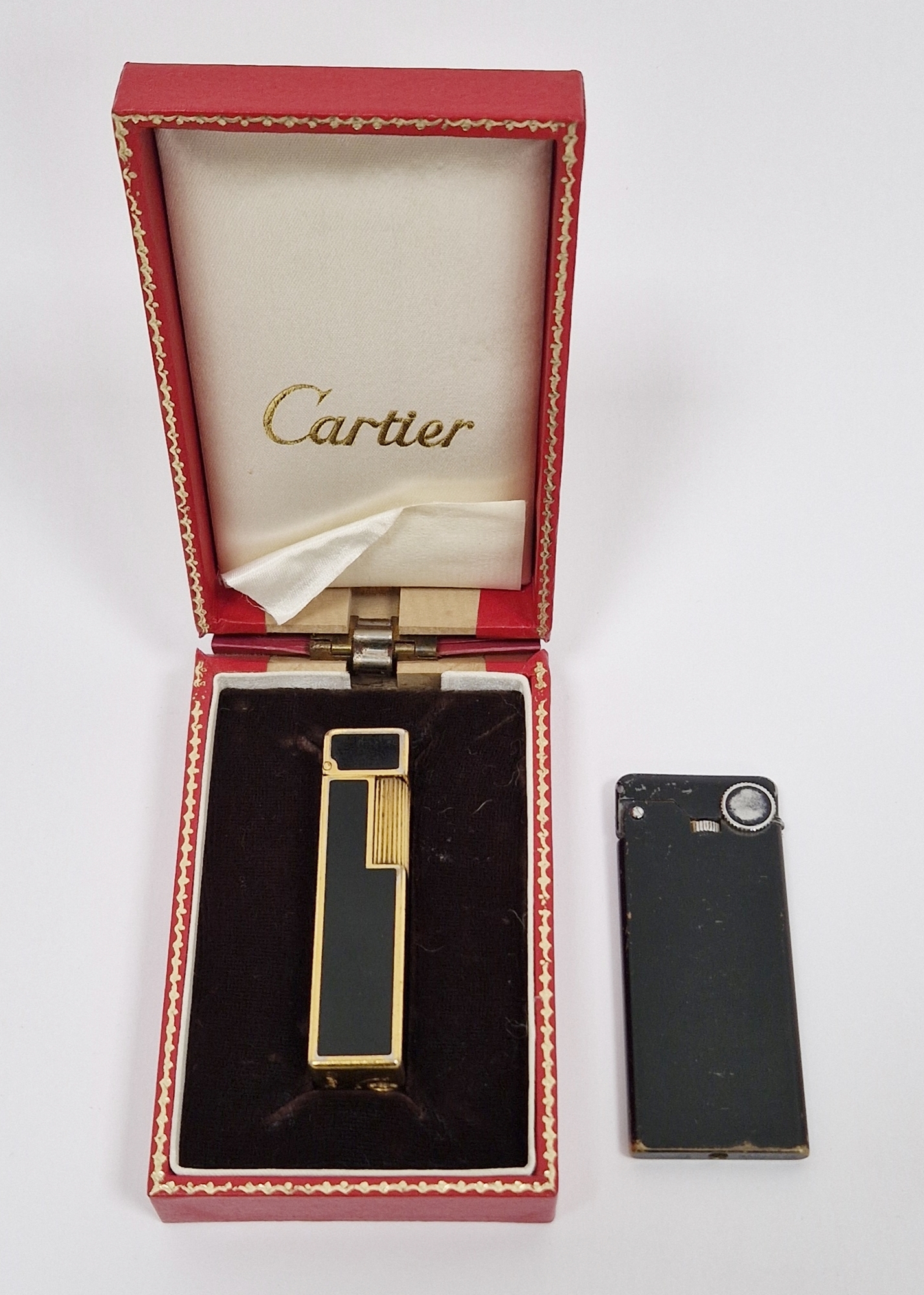 Cartier gold-plated and black enamel lighter of square section, boxed, and a Prince Racing 45 slim-