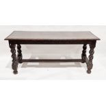 Stained oak Jacobean-style dining table of rectangular form with carved floral decoration to the