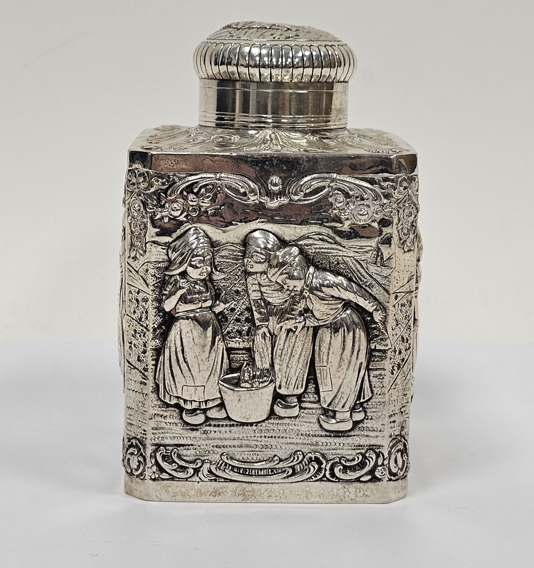 Dutch silver-coloured metal tea caddy, square-section, the domed cover with picture of boy beside