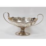 George V silver twin-handled boat-shaped fruit bowl with wavy rim, on oval pedestal base,