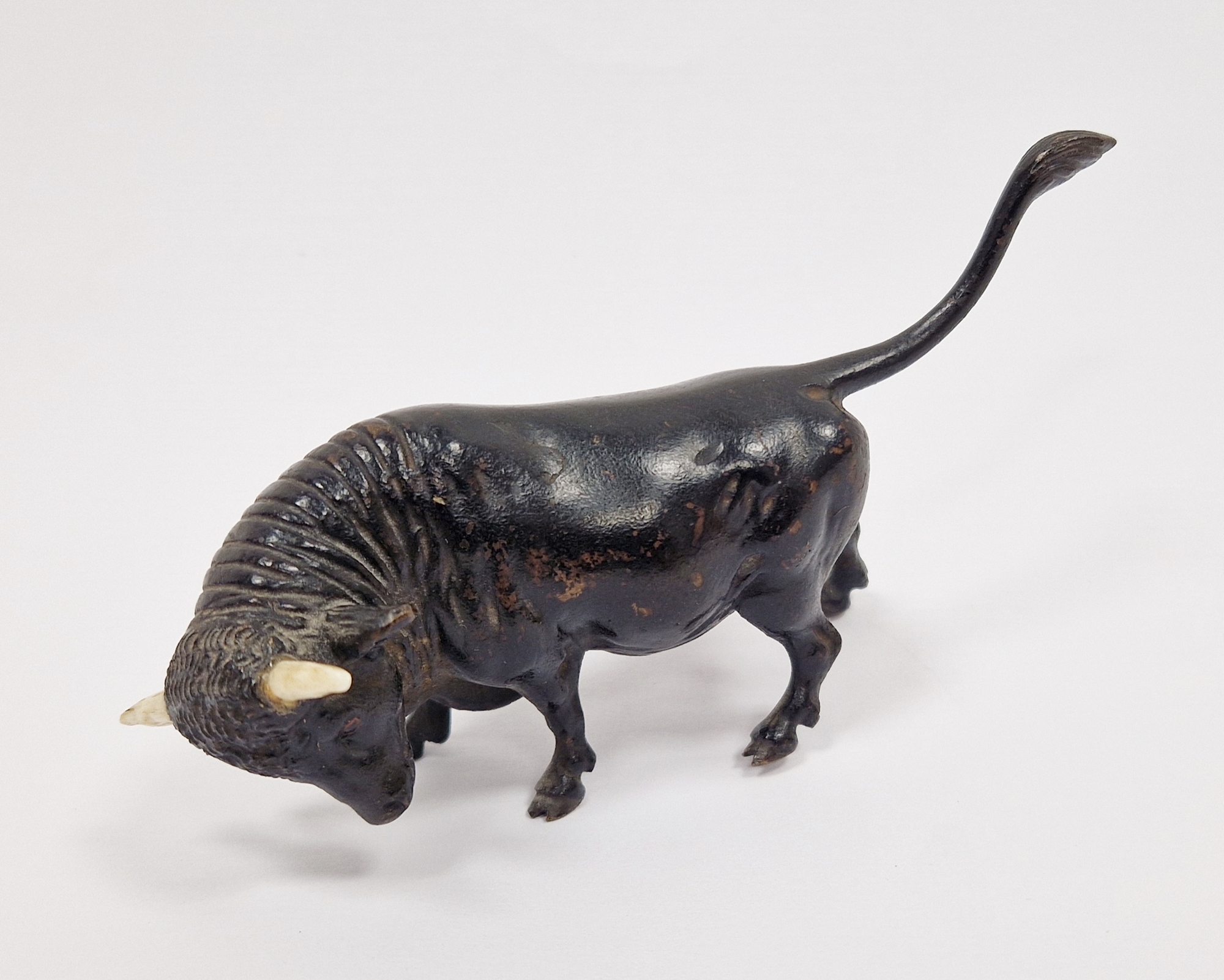 Patinated bronze and bone-mounted miniature model of a bull, 20th century, naturalistically cast