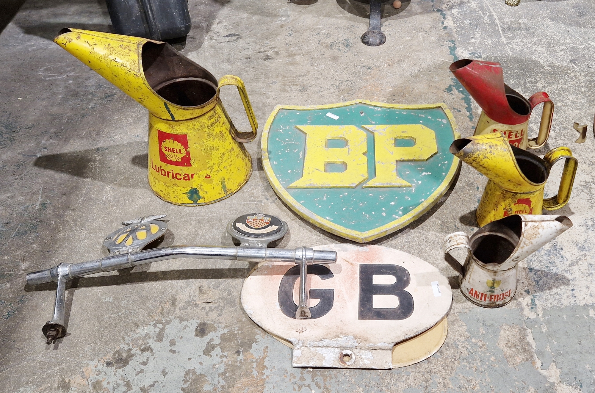 Collection of vintage motoring items to include a metal BP sign painted green and yellow, a Shell