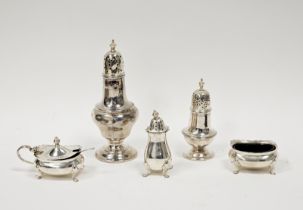 Selection of silver condiments including pepper shakers, lidded mustard and open salt and a silver