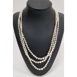 LOT WITHDRAWN Triple string of graduated pearls with 9ct gold, pearl and garnet clasp