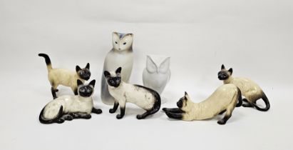 Two Beswick pottery models of Siamese cats and three similar, printed black marks and impressed