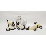 Two Beswick pottery models of Siamese cats and three similar, printed black marks and impressed