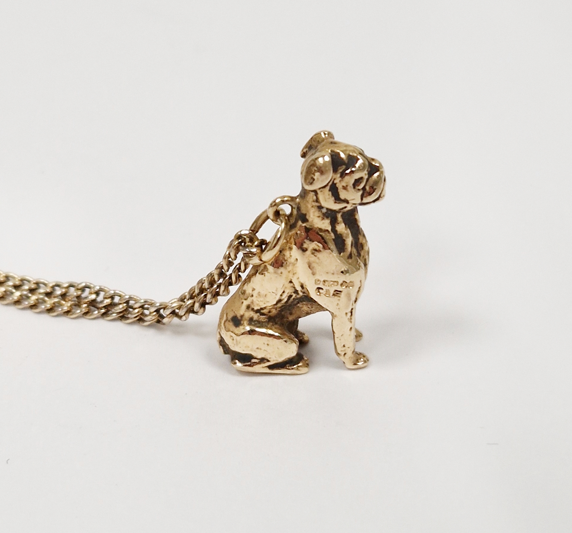 9ct gold bulldog pendant on 9K curb link chain, 15.56g total approx.