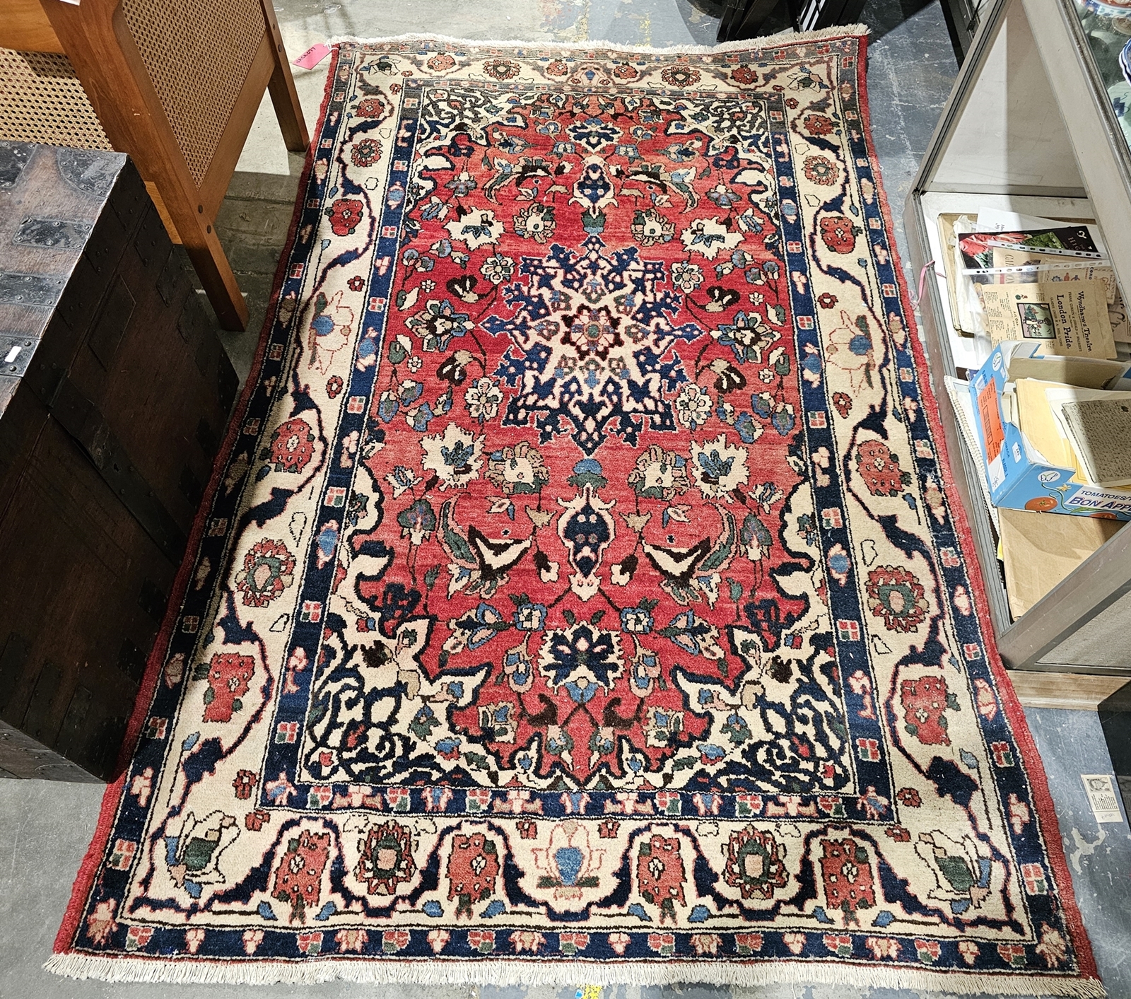 Large red ground rug with central floral medallion on floral field and floral spandrels, multiple