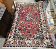 Large red ground rug with central floral medallion on floral field and floral spandrels, multiple