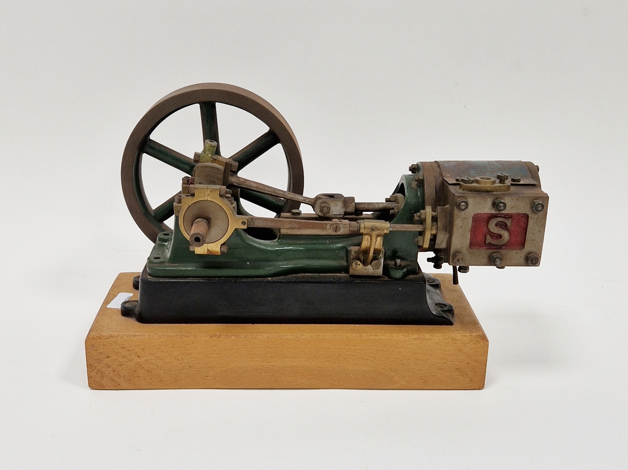 Model, stationary single cylinder steam engine by Stuart, on a wooden base, 20cm long