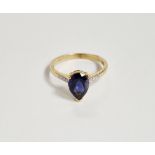 10K gold, blue stone and diamond ring set pear-shaped claw set stone, possibly tanzanite, with small