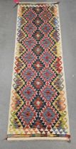 Chobi kilim blue ground runner, with two rows of seven lozenges and row of six, 242cm x 80cm