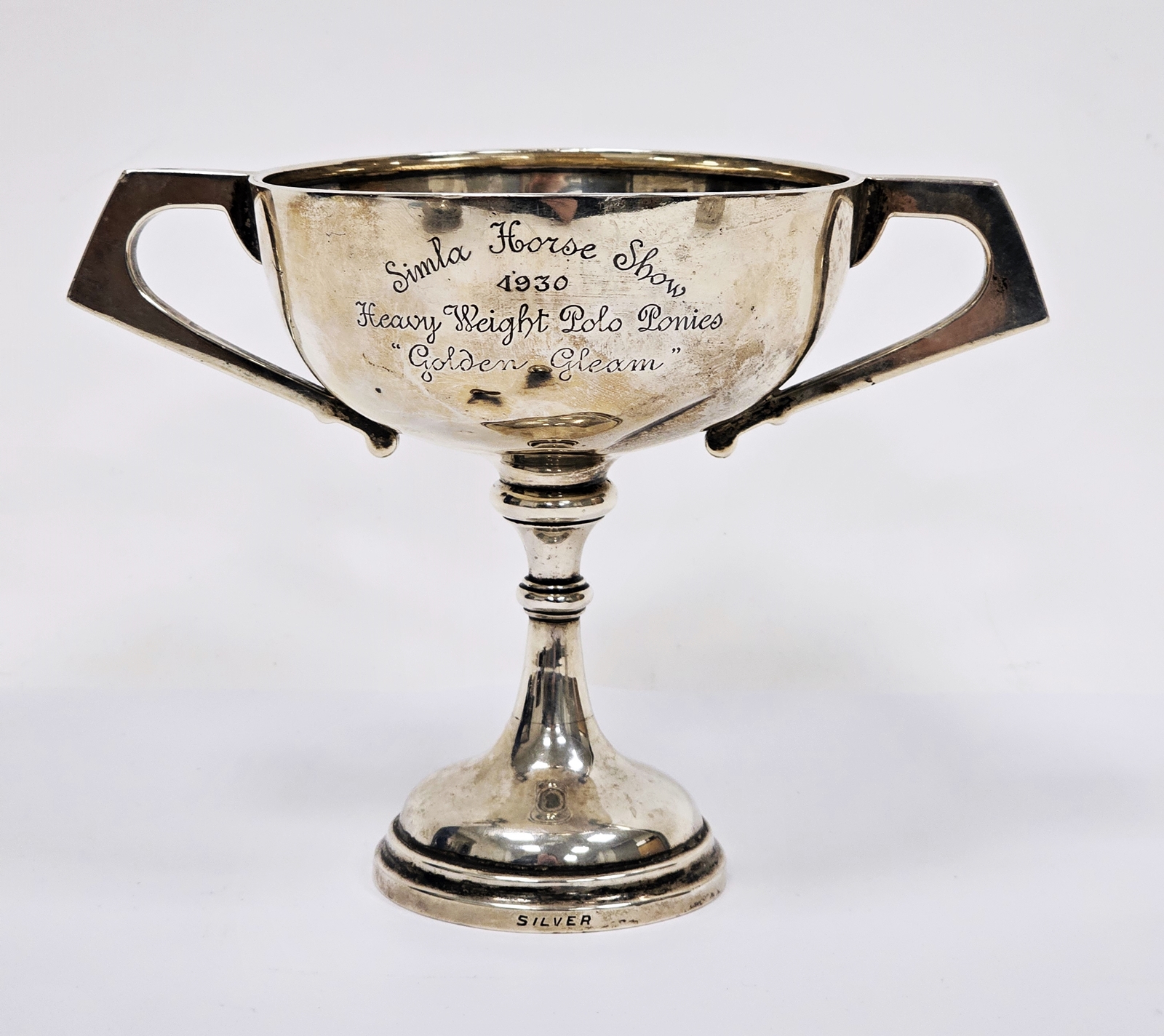 Indian silver-coloured two-handled trophy cup, circular bowl with angular flattened handles engraved