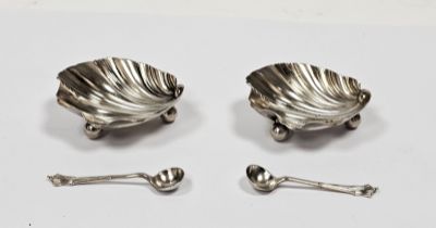 Pair late Victorian silver salt cellars, each shell-shaped and raised on three ball feet and a