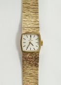 Vintage lady's 9ct gold Omega wristwatch, the square silvered dial with raised black baton hour