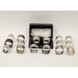 A collection of various silver and white metal napkin rings, including British and continental