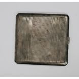 Elizabeth II silver cigarette case with Art Deco-style engine-turned decoration, gilt interior,