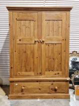 Pine two-door wardrobe over a single long drawer, 185cm high x 130cm wide x 60cm deep