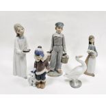 Collection of Lladro figures comprising a girl with candlestick, a boy holding two pails, a boy