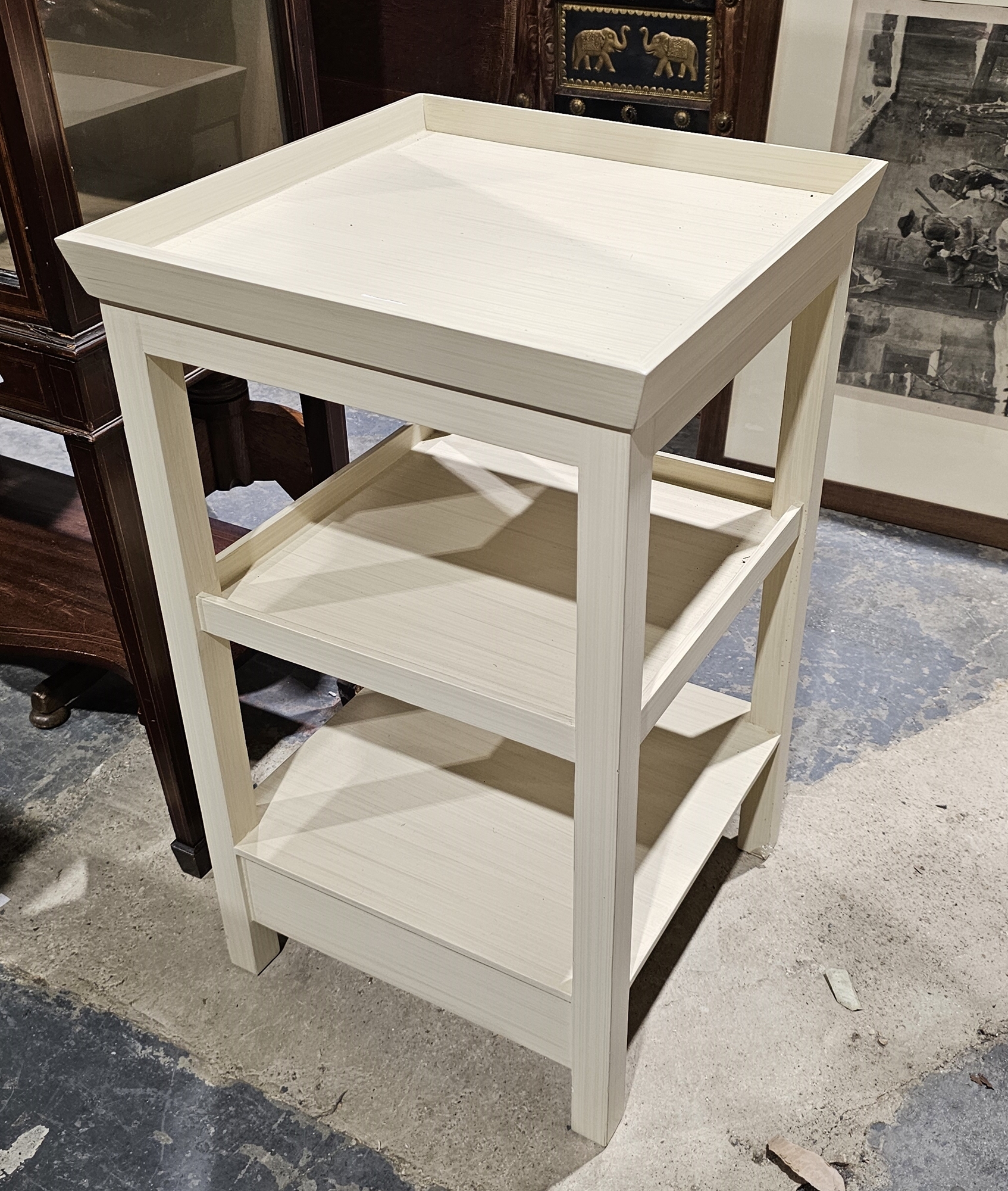 Modern three-tier cream painted side table, 72cm high x 42cm wide x 43cm deep