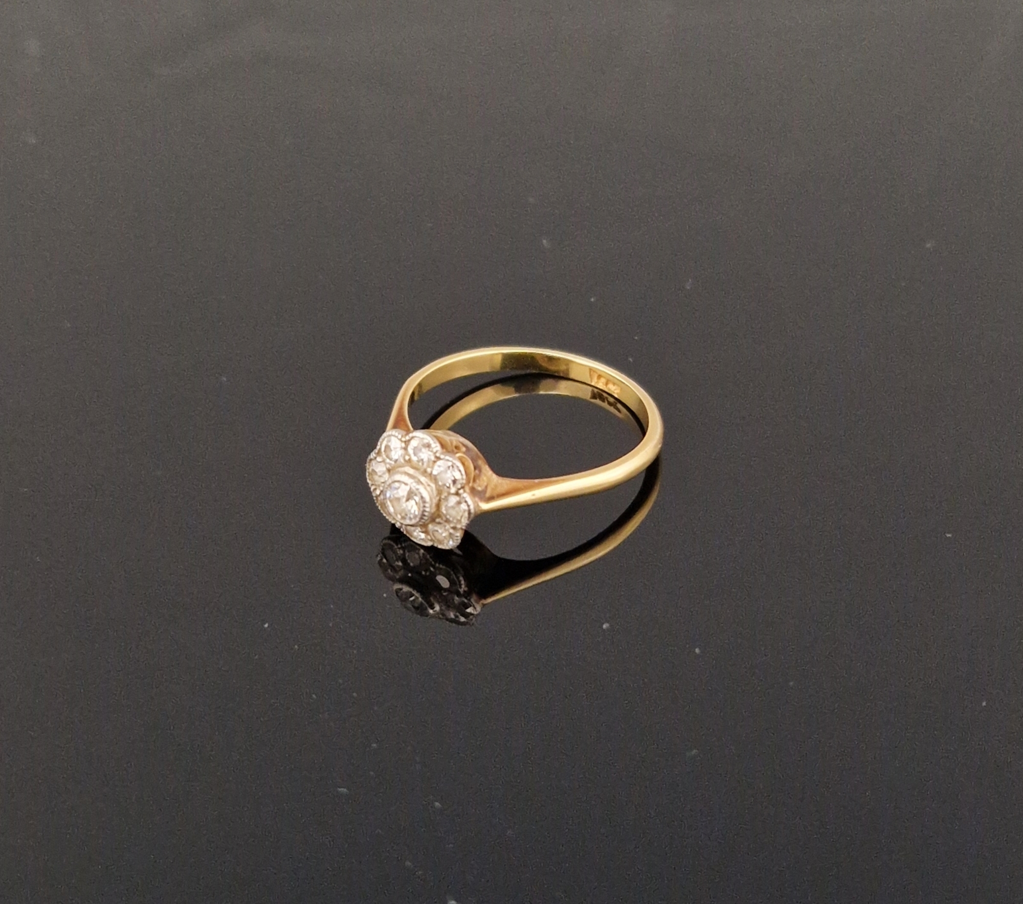 18ct gold and diamond cluster ring, having nine stones, circa 1920's  Condition Report Ring size -