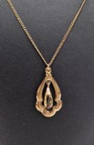 9ct gold shaped openwork pendant with citrine drop to the centre, on fine curb-link 9ct gold