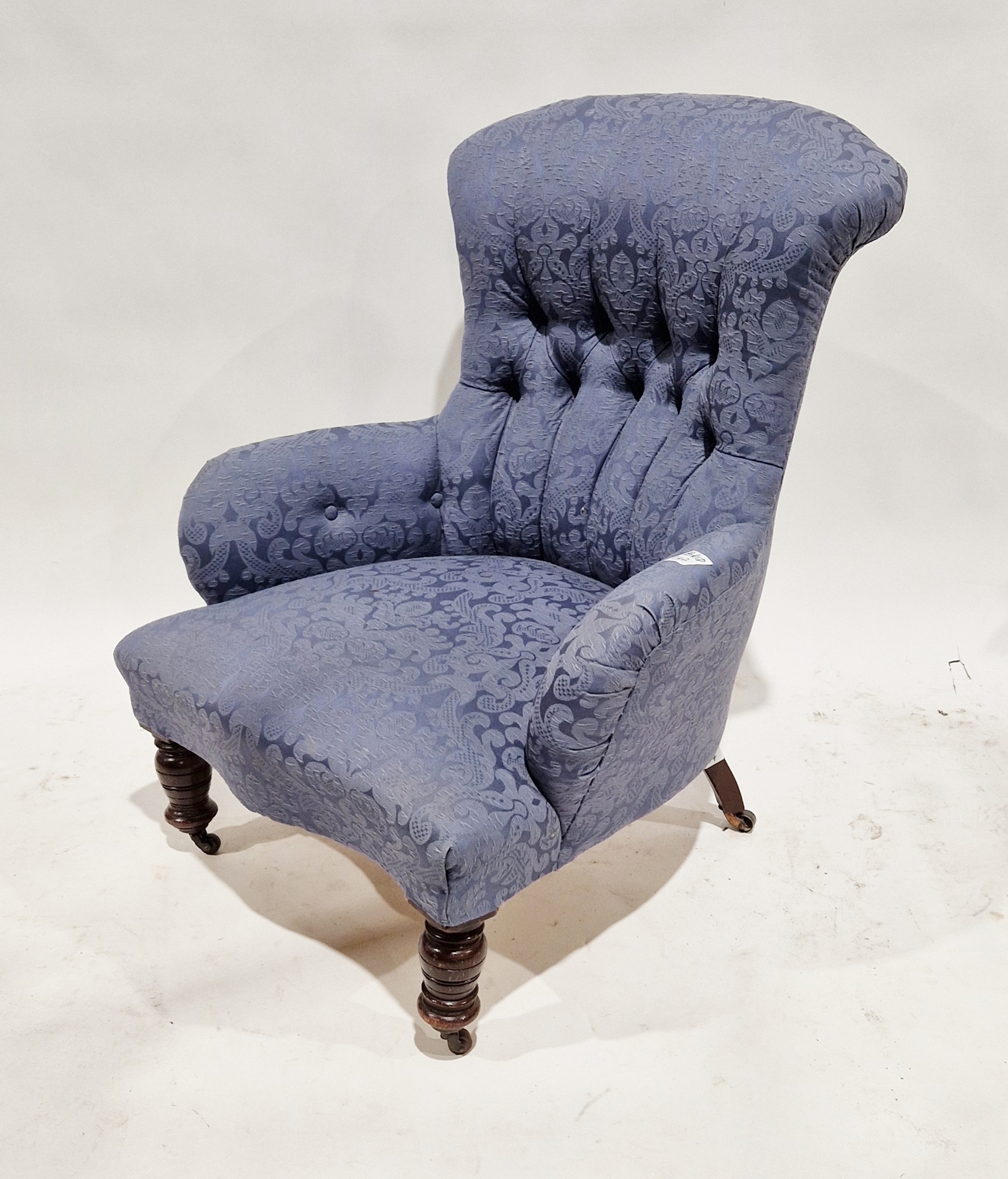 Late 19th/early 20th century armchair with partial buttonback and later upholstery, on castors, 77cm