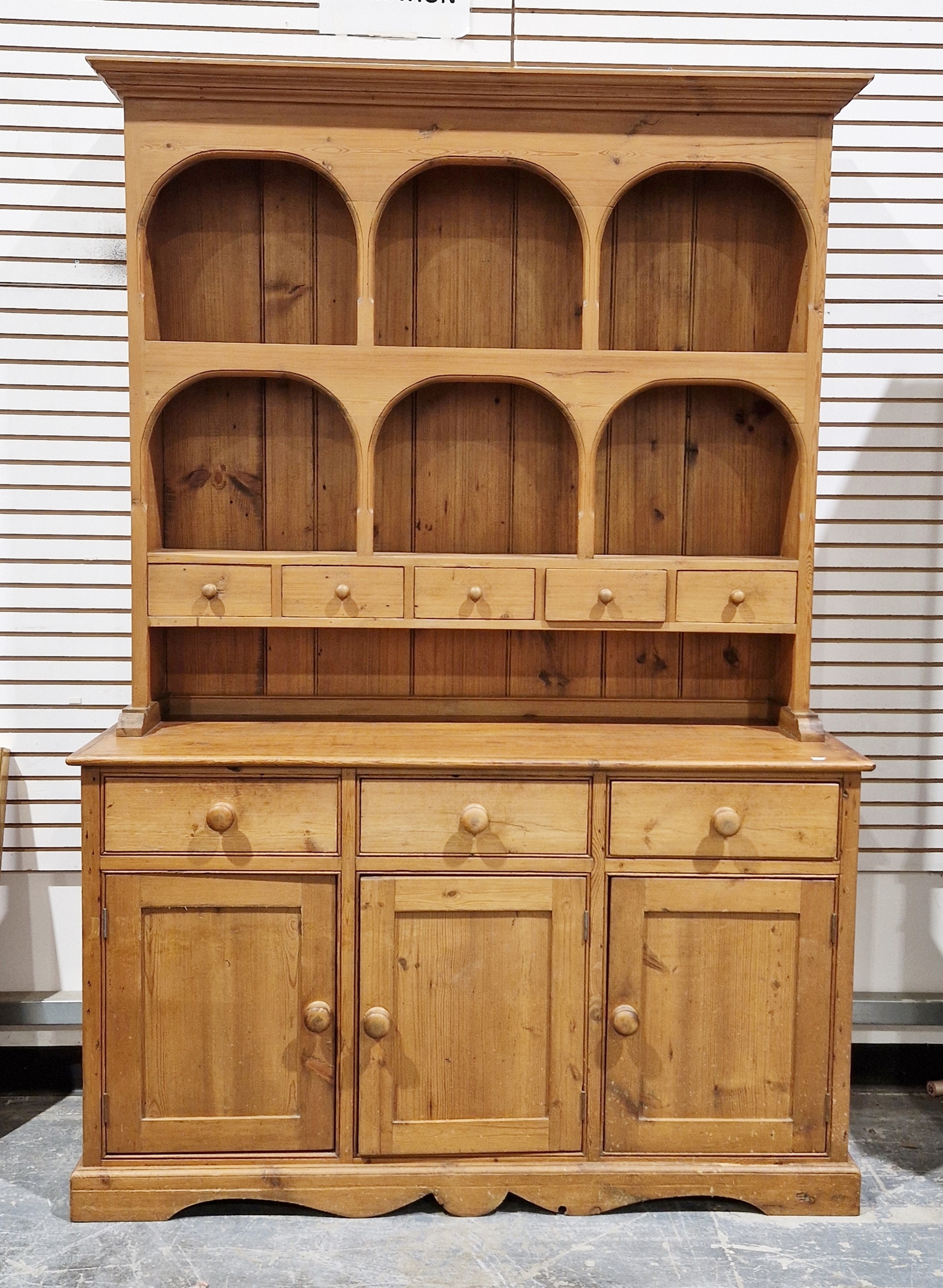 19th century pine kitchen dresser, the top section with two plateracks and five short drawers, the