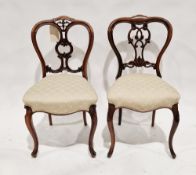 Two Victorian balloonback dining chairs, one rosewood, the other mahogany, each raised on cabriole