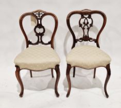 Two Victorian balloonback dining chairs, one rosewood, the other mahogany, each raised on cabriole