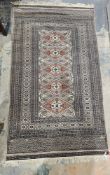 Possibly Afghan grey ground silk rug with five central lozenge medallions on stylised geometric