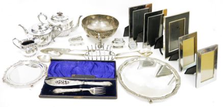 Silver plated salver raised on claw and ball feet, a smaller silver plated card tray, various silver