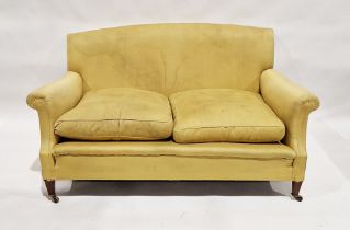 Late 19th/early 20th century Howard & Sons sofa upholstered in a gold fabric, on mahogany legs