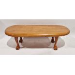 Stained hardwood coffee table of rounded rectangular form, on claw and ball feet, 38cm high x