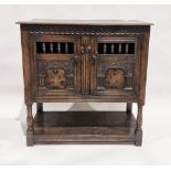 18th century oak dole cupboard, the two cupboard doors with turned spindle sections, carved and