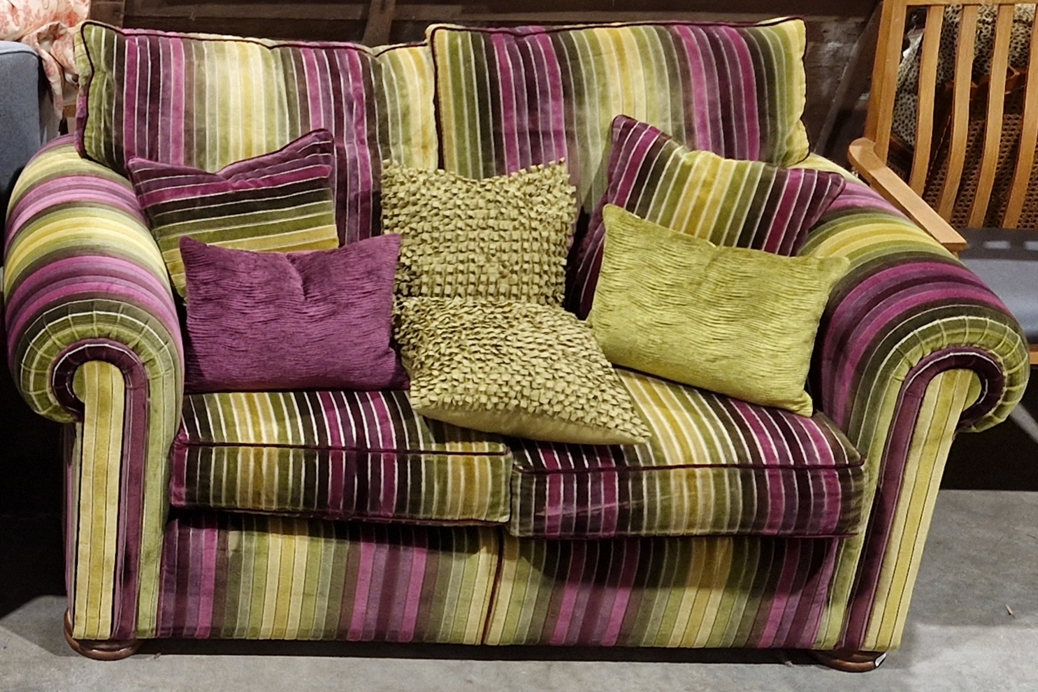 Duresta two-seater sofa covered in a multi-coloured fabric, with a selection of cushions, 166cm wide