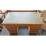 Early 20th century kneehole desk having a central long drawer flanked on either side by four short