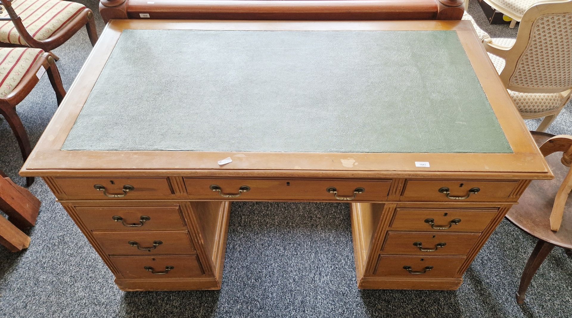 Early 20th century kneehole desk having a central long drawer flanked on either side by four short