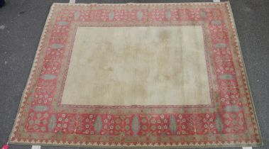 Large wool carpet of revived Eastern style, having stiff leaf and floral spray iron red border and
